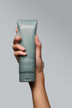 Alpha-H Clear Skin Face & Body Wash tubo en la mano