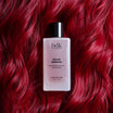 BDK Parfums Hair Perfume Rouge Smoking frasco sobre cabello rojo