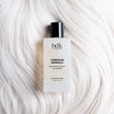 BDK Parfums Hair Perfume Tubereuse Imperiale frasco sobre cabello rubio platino