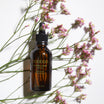 Oolaboo Essential Cocktail Purifying entre florecillas rosas