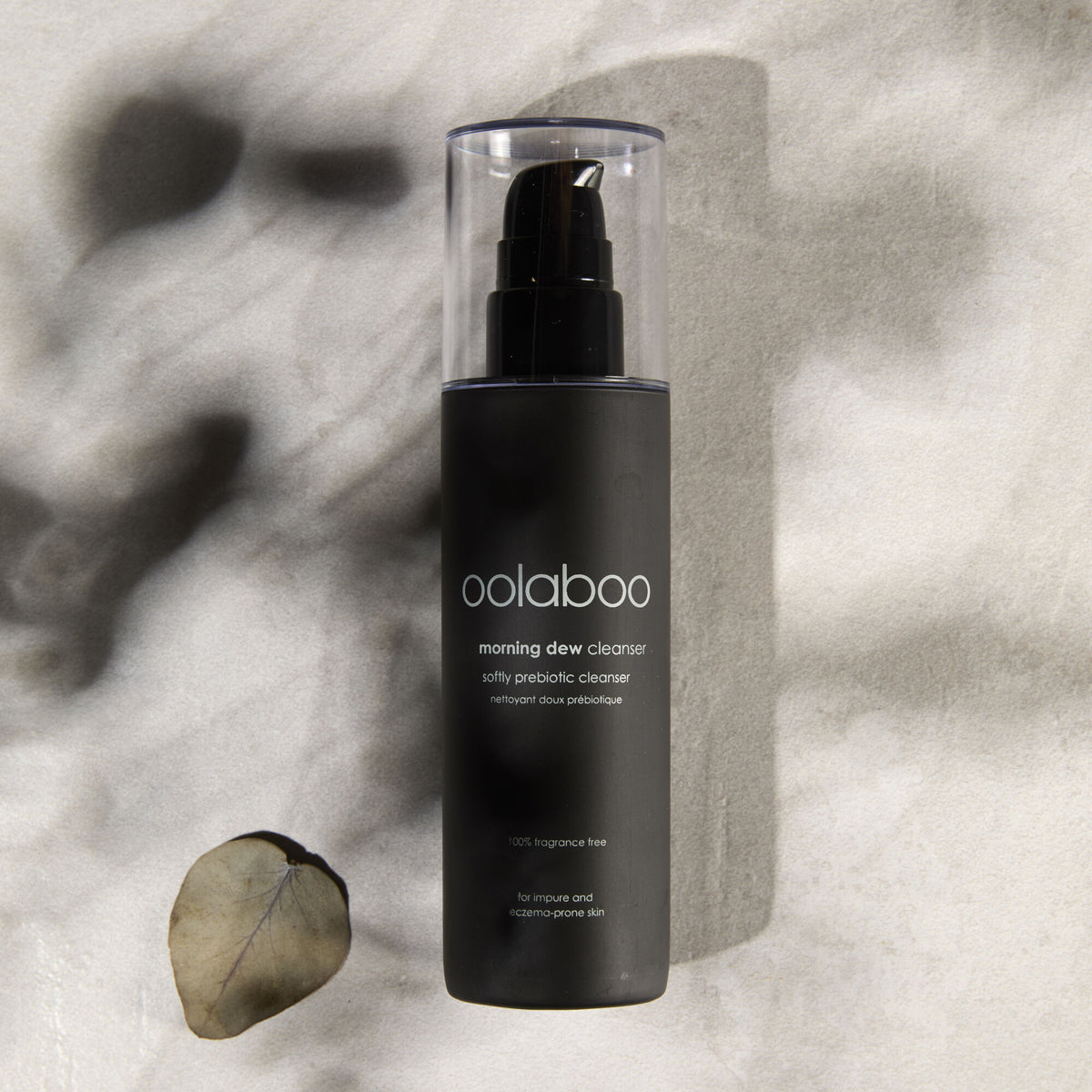 Oolaboo Morning Dew Softly Prebiotic Cleanser sobre lino con hojas